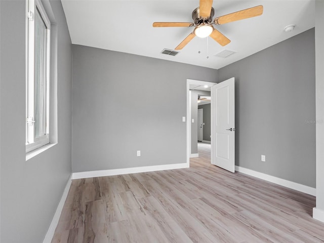 540 80th Ave, St Pete Beach, FL 33706 - unfurnished bedroom featuring wood finished floors and a ceiling fan
