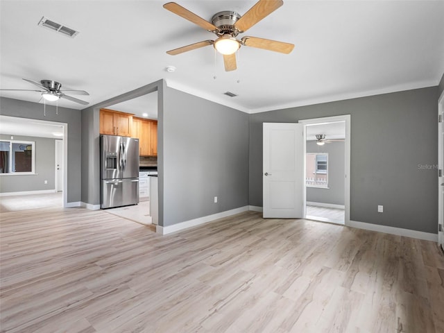 540 80th Ave, St Pete Beach, FL 33706 - unfurnished living room featuring a ceiling fan and light wood-style floors