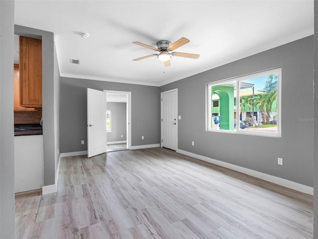 540 80th Ave, St Pete Beach, FL 33706 - unfurnished living room with ceiling fan and light wood-style floors