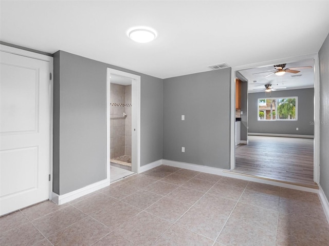 540 80th Ave, St Pete Beach, FL 33706 - unfurnished bedroom with light tile patterned floors and connected bathroom