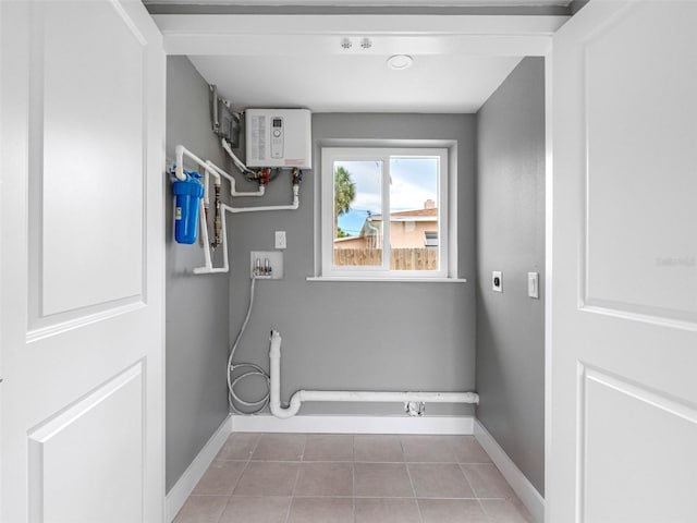 540 80th Ave, St Pete Beach, FL 33706 - laundry room featuring electric dryer hookup, hookup for a washing machine, light tile patterned flooring, and water heater