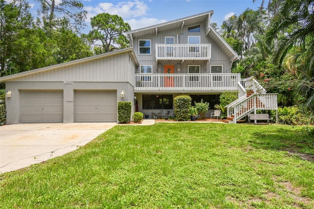 12835 74th Ave, Seminole, FL 33776 - view of front facade featuring a balcony, concrete driveway, a garage, a front yard, and stairway