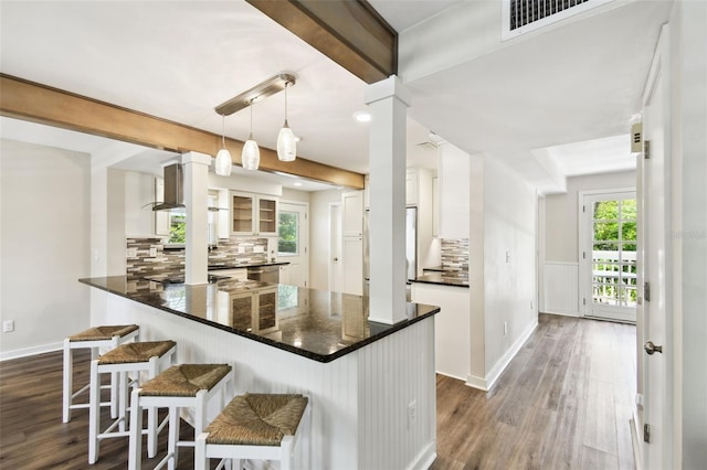 12835 74th Ave, Seminole, FL 33776 - kitchen featuring white cabinetry, dark wood-type flooring, and decorative backsplash