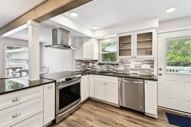 12835 74th Ave, Seminole, FL 33776 - kitchen featuring stainless steel appliances, extractor fan, plenty of natural light, and dark stone counters