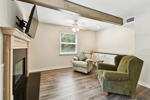 12835 74th Ave, Seminole, FL 33776 - sitting room featuring a glass covered fireplace, wood finished floors, a ceiling fan, and recessed lighting