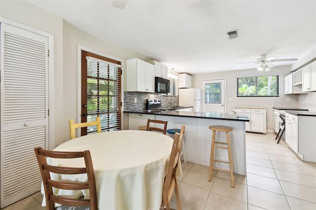 12835 74th Ave, Seminole, FL 33776 - dining area with ceiling fan and light tile patterned floors