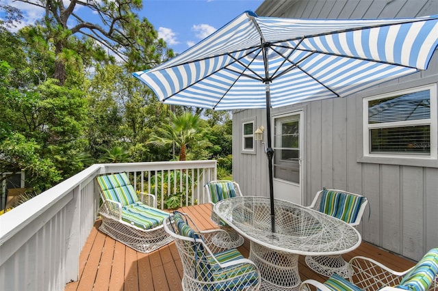 12835 74th Ave, Seminole, FL 33776 - wooden terrace with outdoor dining space