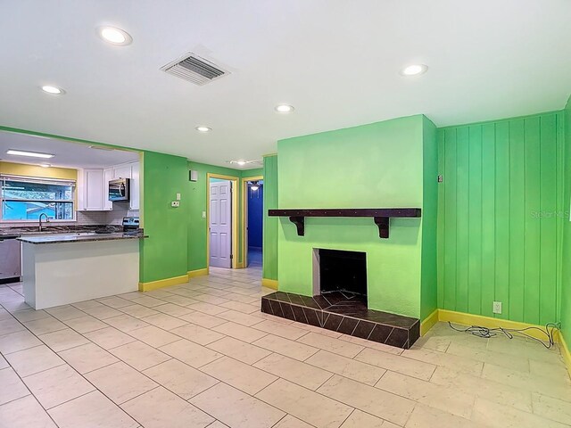 6428 Old Main St, New Port Richey, FL 34653 - unfurnished living room with a fireplace and recessed lighting