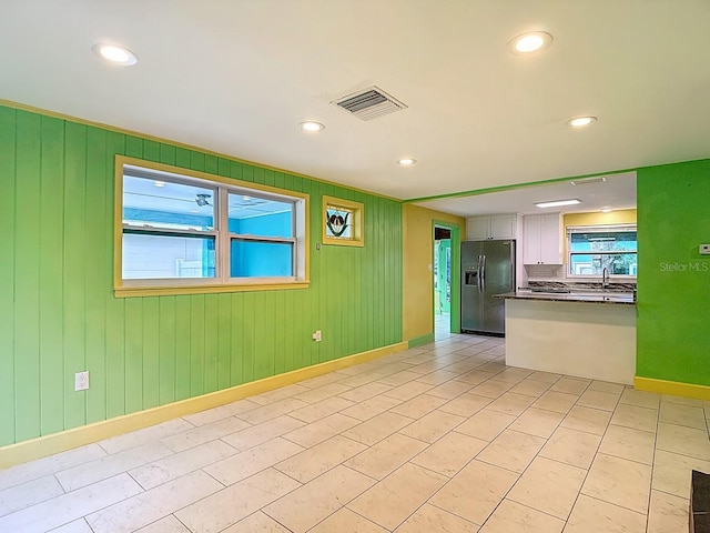 6428 Old Main St, New Port Richey, FL 34653 - empty room with recessed lighting and wood walls