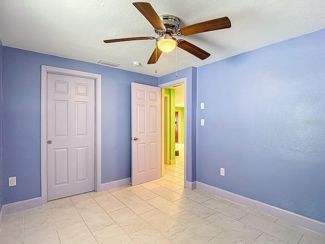 6428 Old Main St, New Port Richey, FL 34653 - unfurnished bedroom with ceiling fan and a textured ceiling