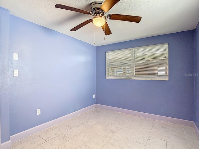6428 Old Main St, New Port Richey, FL 34653 - empty room with light marble finish flooring, ceiling fan, and a textured ceiling