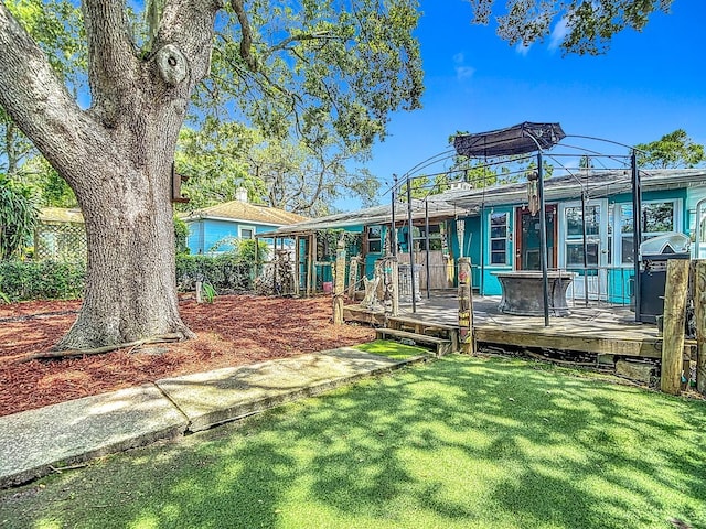 6428 Old Main St, New Port Richey, FL 34653 - back of house with a yard and a wooden deck