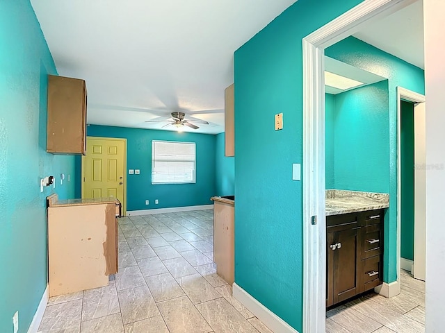 6428 Old Main St, New Port Richey, FL 34653 - kitchen with a ceiling fan, dark brown cabinetry, and light countertops