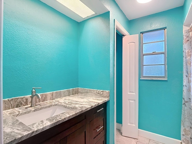6428 Old Main St, New Port Richey, FL 34653 - full bathroom with vanity, a textured wall, and curtained shower