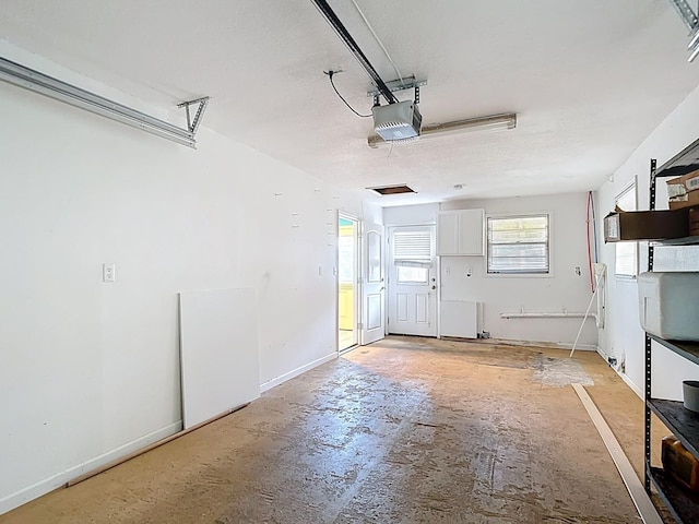 6428 Old Main St, New Port Richey, FL 34653 - garage featuring a garage door opener and baseboards