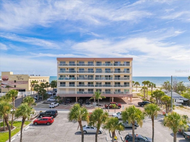 13000 Gulf Blvd Unit 309, Madeira Beach, FL 33708 - view of apartment building / complex featuring uncovered parking and a water view