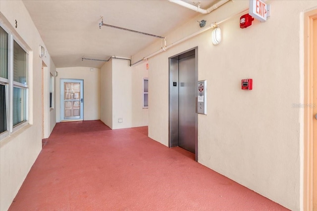 13000 Gulf Blvd Unit 309, Madeira Beach, FL 33708 - hallway with carpet, elevator, and vaulted ceiling