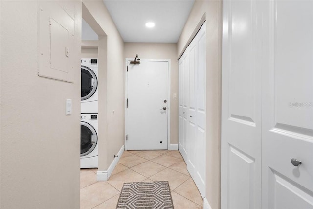 13000 Gulf Blvd Unit 309, Madeira Beach, FL 33708 - laundry room with stacked washer and clothes dryer, electric panel, light tile patterned flooring, and recessed lighting