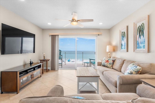 13000 Gulf Blvd Unit 309, Madeira Beach, FL 33708 - living room with ceiling fan, light tile patterned floors, a water view, and recessed lighting