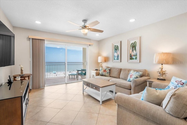 13000 Gulf Blvd Unit 309, Madeira Beach, FL 33708 - living room with ceiling fan, light tile patterned floors, a water view, recessed lighting, and a textured ceiling