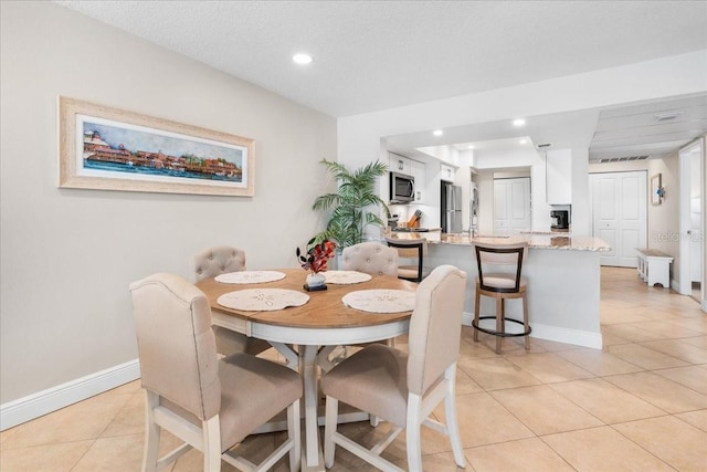 13000 Gulf Blvd Unit 309, Madeira Beach, FL 33708 - dining area featuring light tile patterned floors and recessed lighting