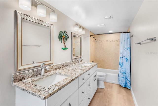 13000 Gulf Blvd Unit 309, Madeira Beach, FL 33708 - bathroom with double vanity, wood finished floors, and shower / tub combo