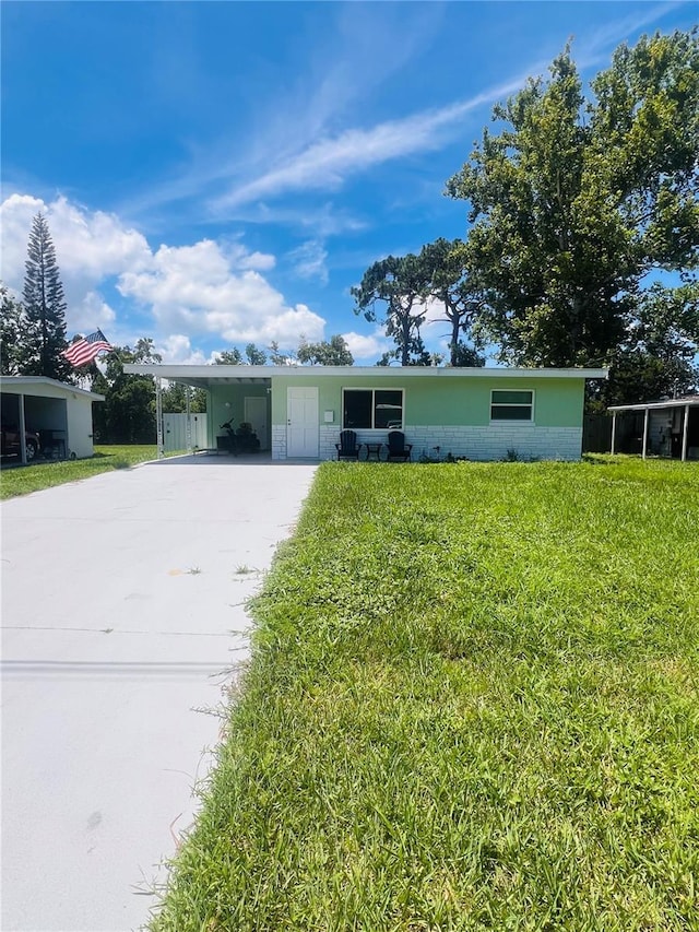 6316 Alaska Ave, New Port Richey, FL 34653 - ranch-style house with a carport, a front lawn, and driveway