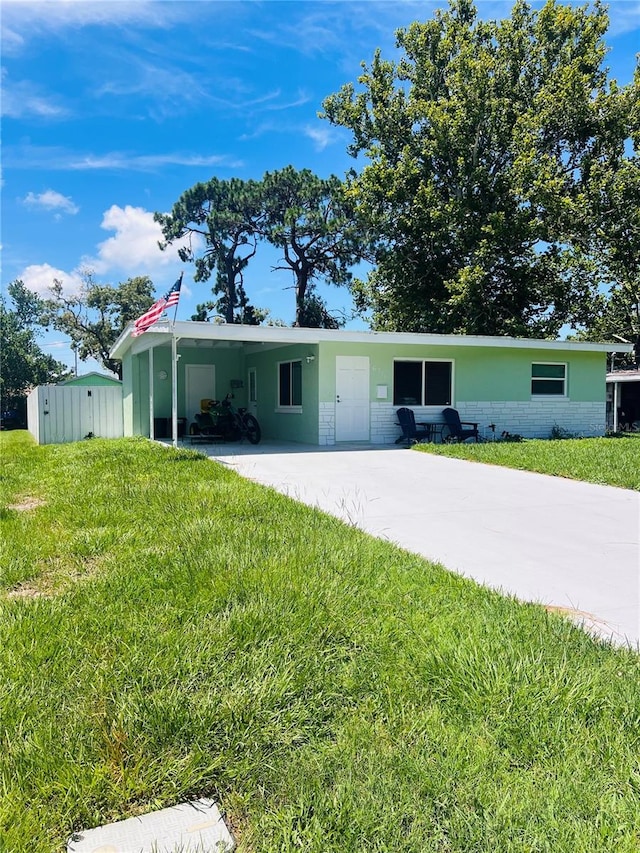 6316 Alaska Ave, New Port Richey, FL 34653 - single story home with a carport, a front yard, concrete driveway, and stucco siding