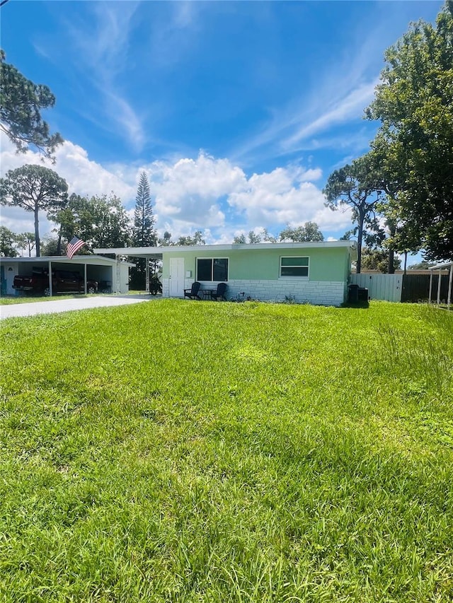 6316 Alaska Ave, New Port Richey, FL 34653 - rear view of house with a carport and driveway