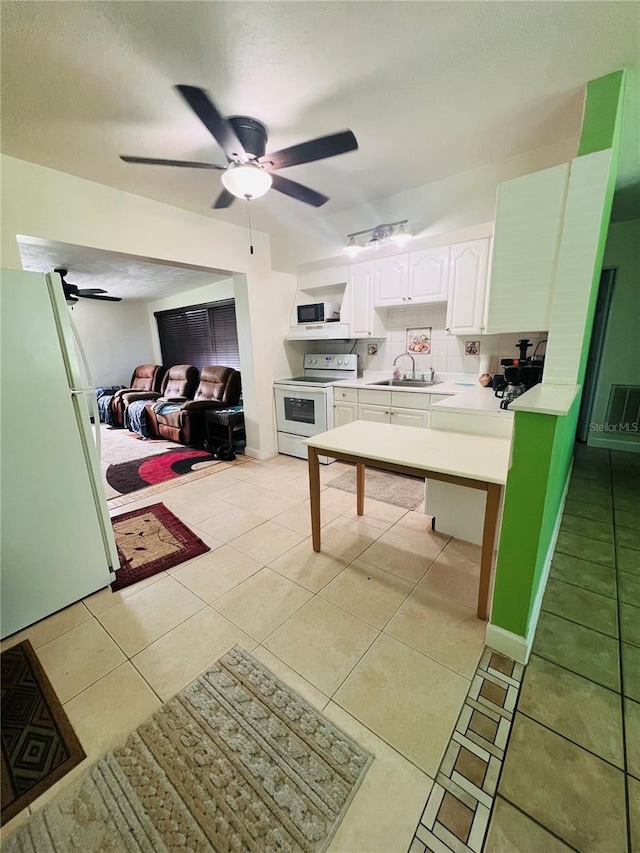 6316 Alaska Ave, New Port Richey, FL 34653 - kitchen featuring white appliances, ceiling fan, white cabinets, and light countertops