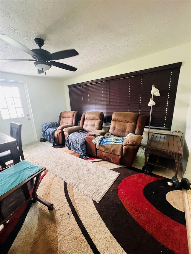 6316 Alaska Ave, New Port Richey, FL 34653 - living area featuring a ceiling fan, carpet floors, and a textured ceiling