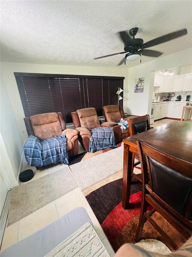 6316 Alaska Ave, New Port Richey, FL 34653 - living area featuring a ceiling fan and a textured ceiling