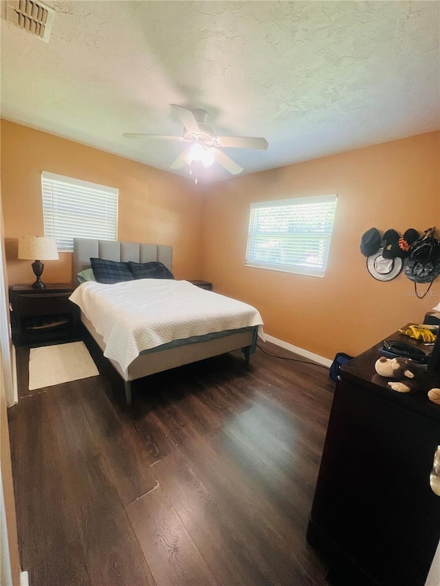 6316 Alaska Ave, New Port Richey, FL 34653 - bedroom with dark wood-style flooring and a ceiling fan