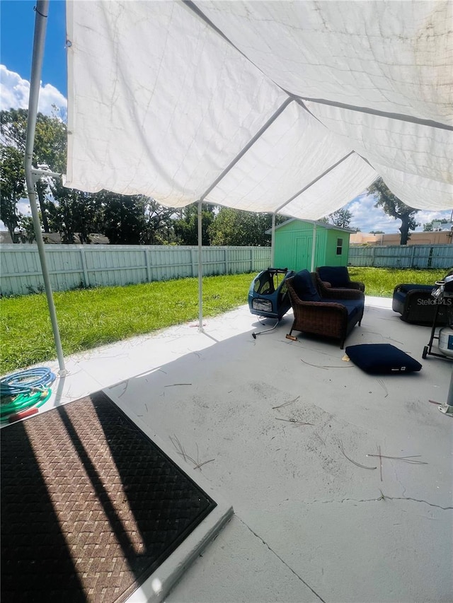 6316 Alaska Ave, New Port Richey, FL 34653 - fenced backyard featuring a shed and a patio area