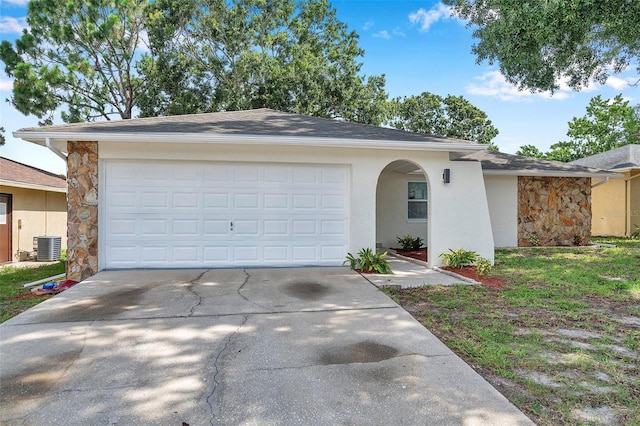 2585 Ridge Ln, Palm Harbor, FL 34684 - view of front of property with concrete driveway, stone siding, and an attached garage