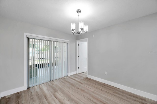 2585 Ridge Ln, Palm Harbor, FL 34684 - empty room with a chandelier and wood finished floors