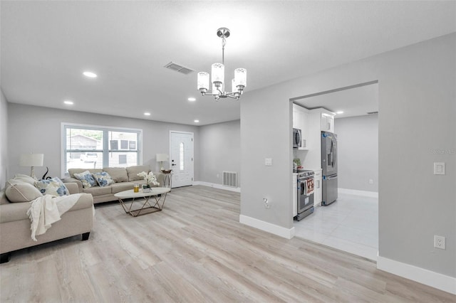2585 Ridge Ln, Palm Harbor, FL 34684 - living room featuring a chandelier, light wood-style flooring, and recessed lighting
