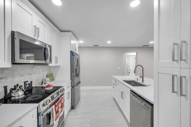 2585 Ridge Ln, Palm Harbor, FL 34684 - kitchen featuring stainless steel appliances, white cabinetry, light countertops, and recessed lighting