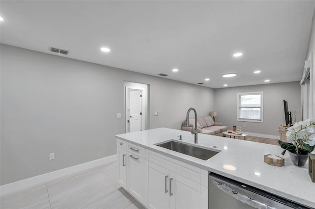 2585 Ridge Ln, Palm Harbor, FL 34684 - kitchen with dishwasher, white cabinets, light stone counters, open floor plan, and recessed lighting