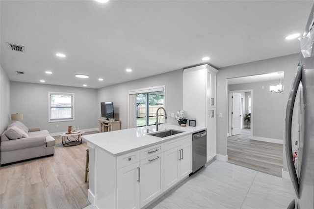 2585 Ridge Ln, Palm Harbor, FL 34684 - kitchen featuring stainless steel dishwasher, light countertops, a peninsula, white cabinets, and recessed lighting