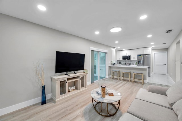 2585 Ridge Ln, Palm Harbor, FL 34684 - living area featuring light wood-style flooring and recessed lighting