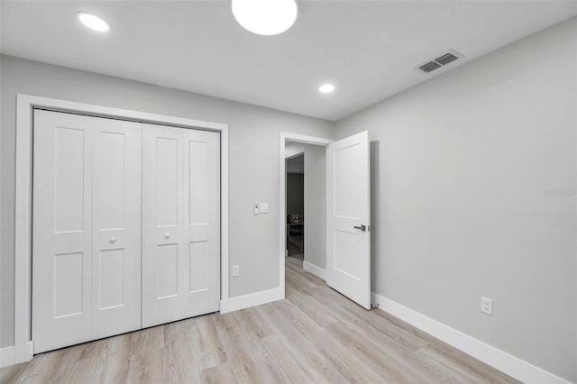 2585 Ridge Ln, Palm Harbor, FL 34684 - unfurnished bedroom with light wood-type flooring, a closet, and recessed lighting