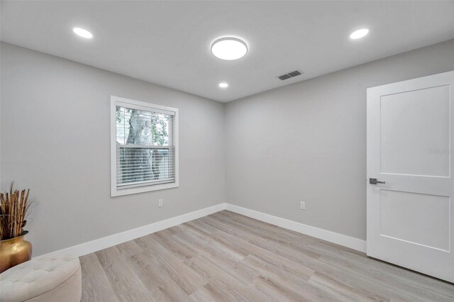 2585 Ridge Ln, Palm Harbor, FL 34684 - empty room featuring light wood-style flooring and recessed lighting