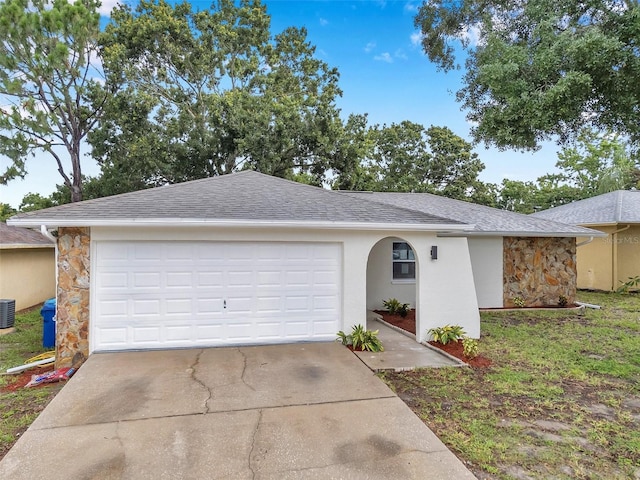 2585 Ridge Ln, Palm Harbor, FL 34684 - ranch-style house featuring concrete driveway, a garage, and stone siding