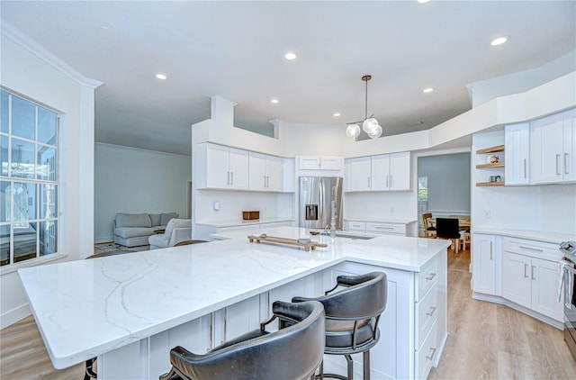 3012 Colonial Ridge Dr, Brandon, FL 33511 - kitchen featuring stainless steel appliances, open shelves, recessed lighting, white cabinets, and a breakfast bar