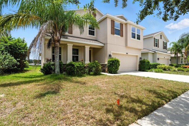 10603 Avian Forrest Dr, Riverview, FL 33578 - view of front of property with stucco siding, a garage, driveway, and a front lawn