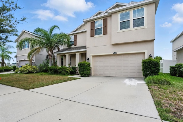 10603 Avian Forrest Dr, Riverview, FL 33578 - view of front facade featuring stucco siding, driveway, an attached garage, and a front lawn