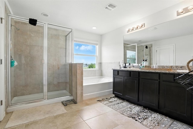 10603 Avian Forrest Dr, Riverview, FL 33578 - bathroom featuring double vanity, a bath, a stall shower, and tile patterned floors