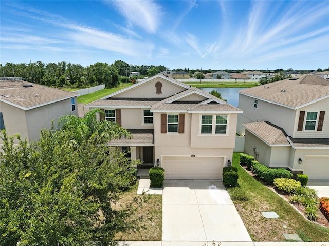 10603 Avian Forrest Dr, Riverview, FL 33578 - traditional-style home with stucco siding, an attached garage, driveway, a water view, and a shingled roof