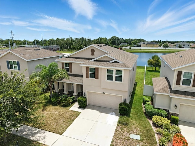 10603 Avian Forrest Dr, Riverview, FL 33578 - traditional home featuring stucco siding, a garage, a shingled roof, and driveway
